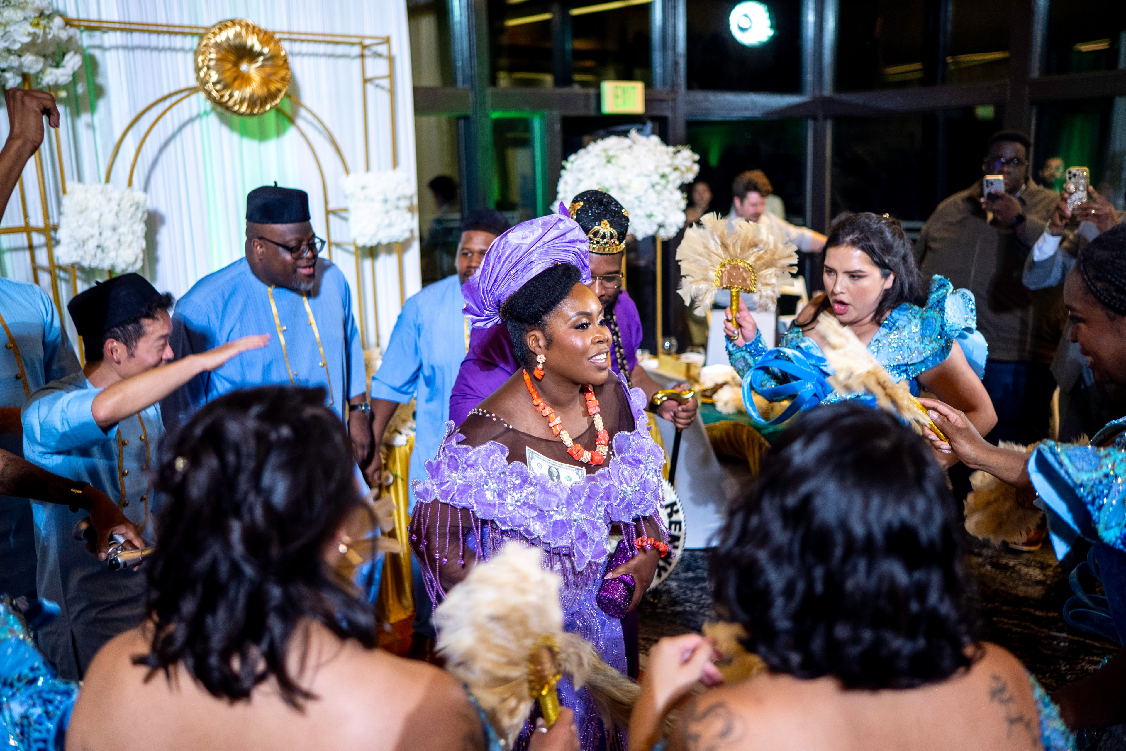 Woman in vibrant purple traditional attire at a cultural celebration