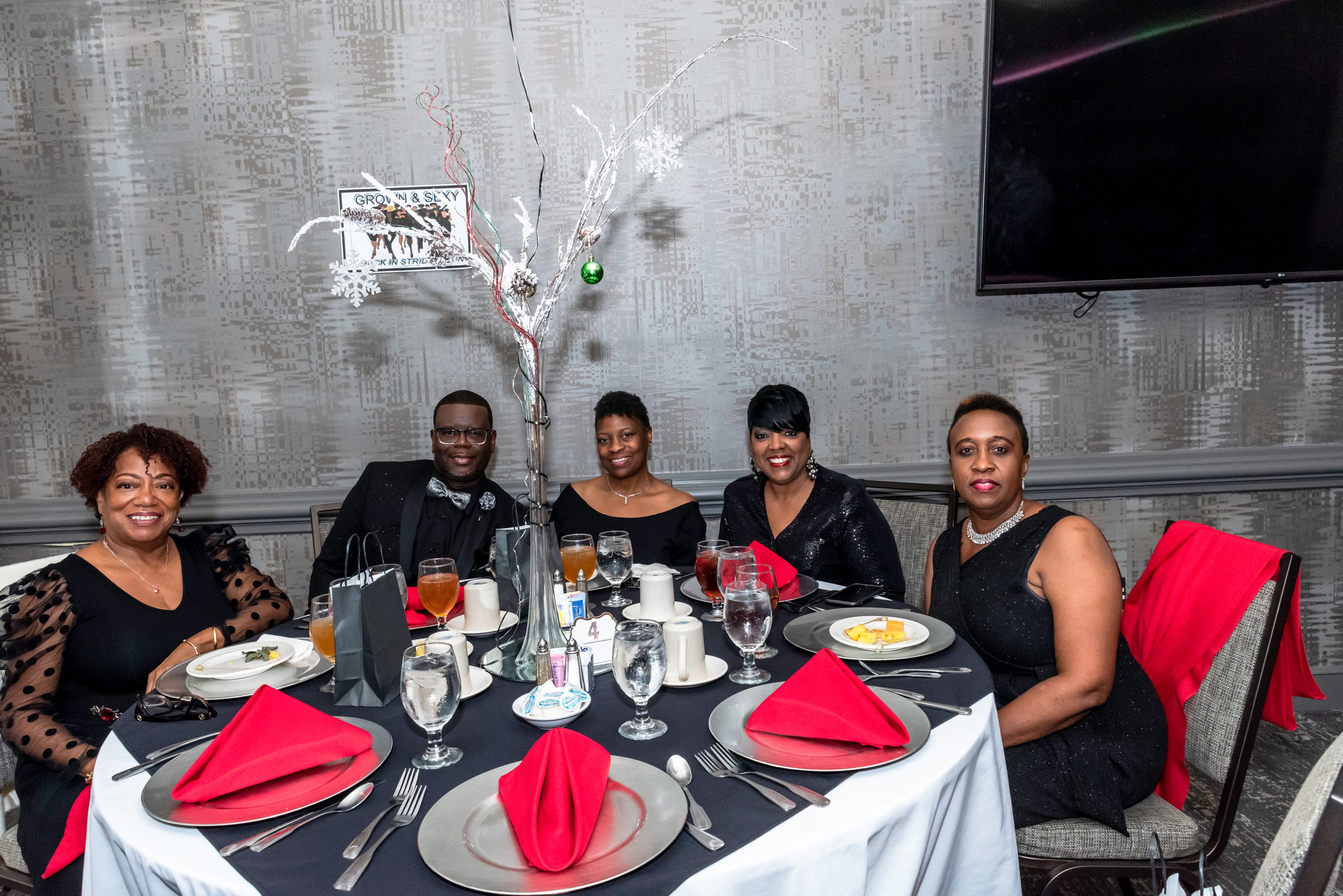 Group of five at an elegant formal dinner event