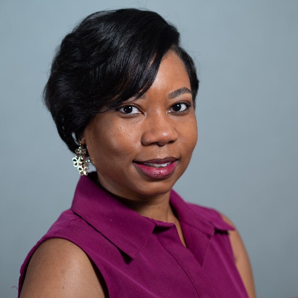 Professional headshot of woman in magenta top