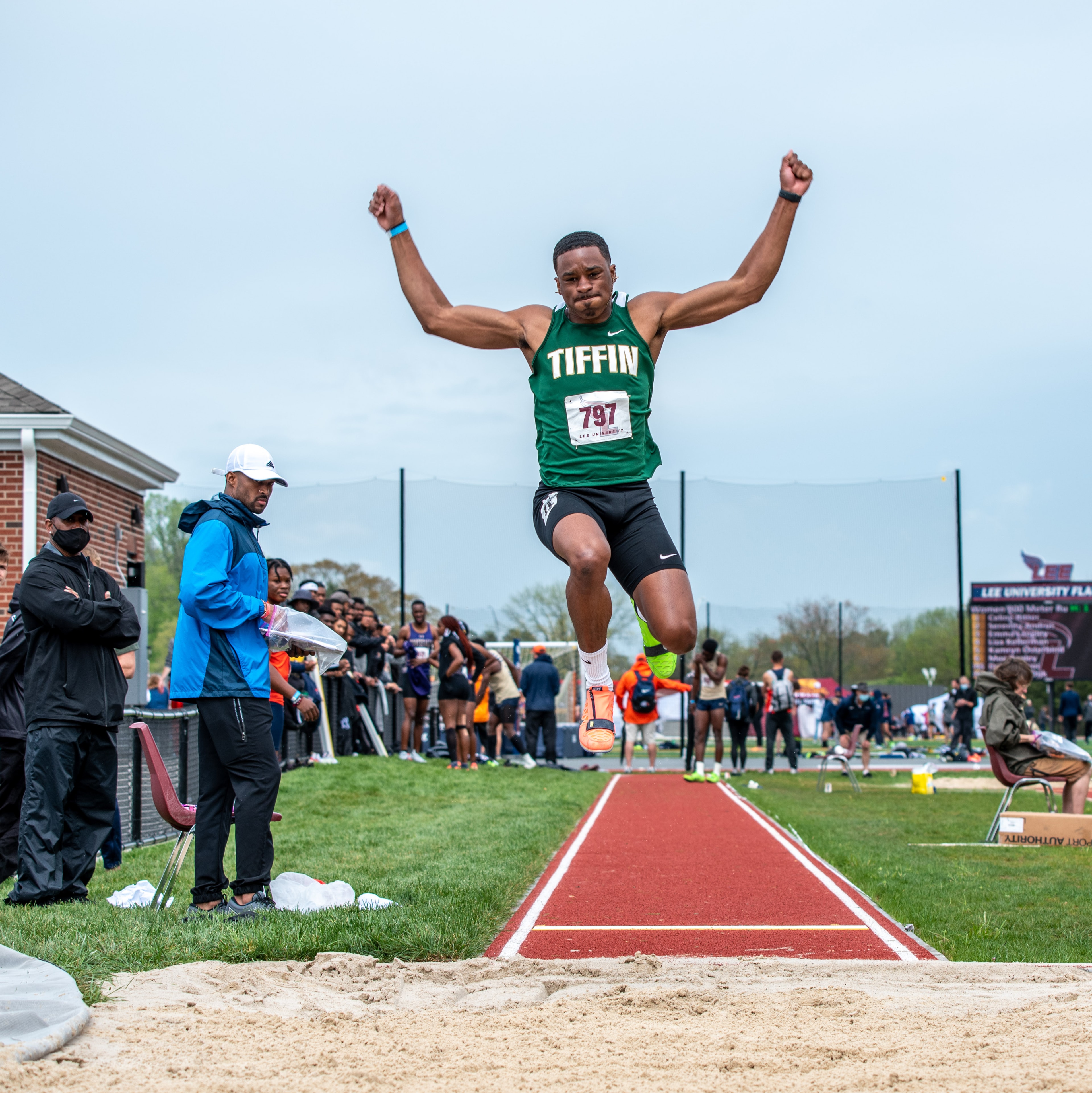Long jumper soaring through the air at track and field meet