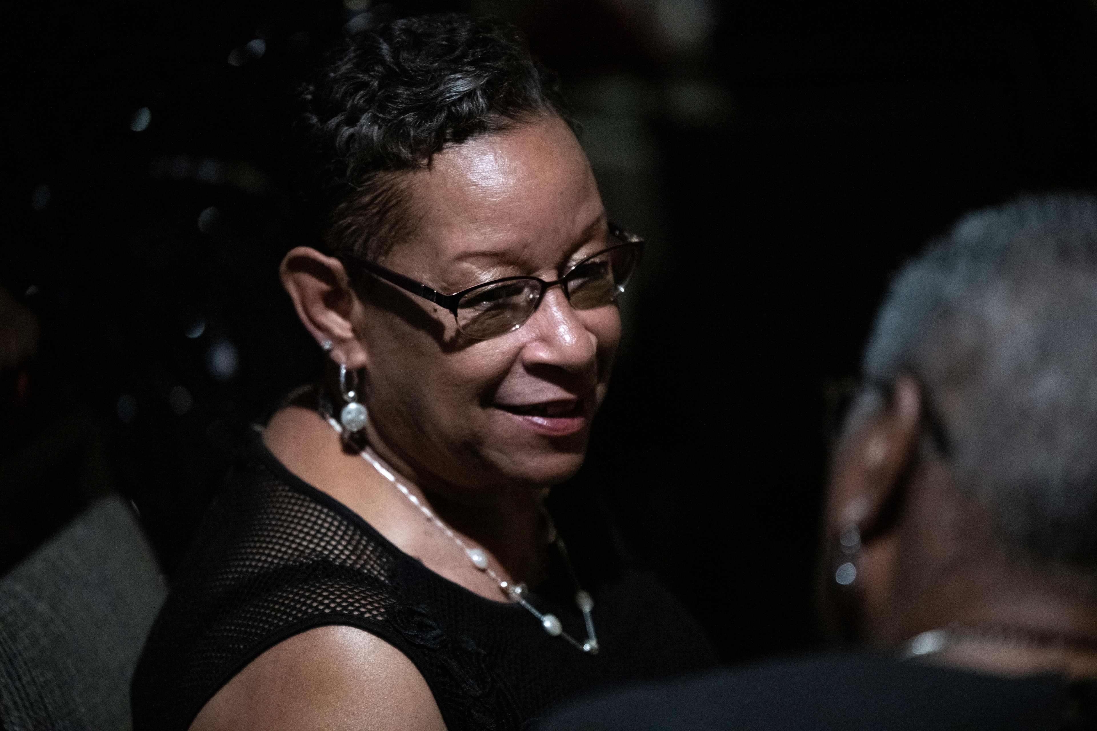 Woman with glasses in a candid low-light portrait